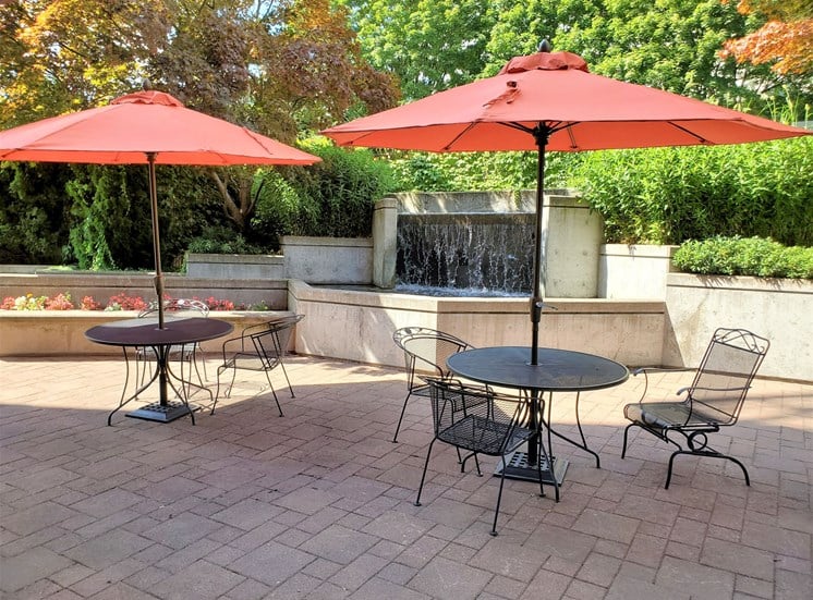 Downtown Portland Apartments - Linc301 Outdoor Seating Area with Shaded Tables and Waterfall Fountain Feature